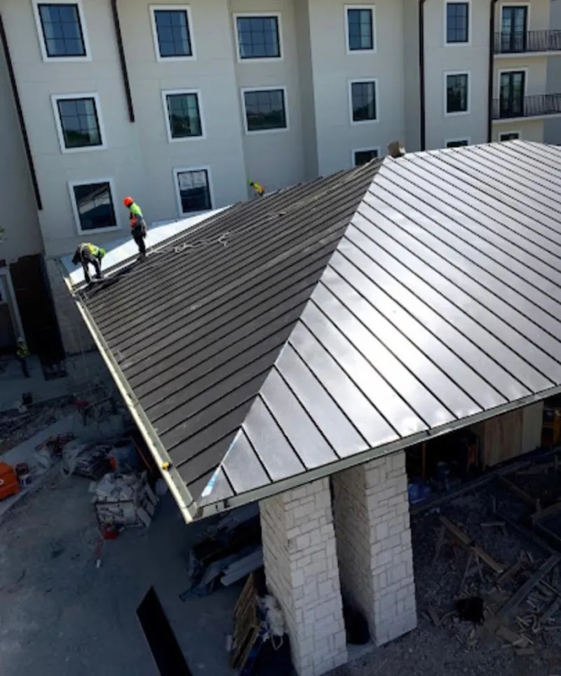 Crew installing standing seam metal roof panels on a commercial project in La CaÃ±ada Flintridge